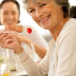 older lady eating strawberry