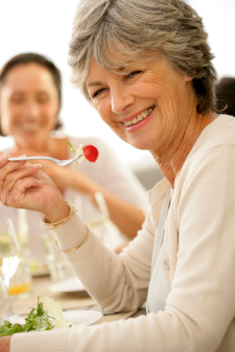 older lady eating strawberry 