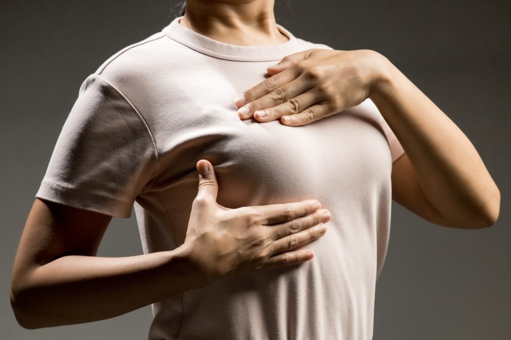 Woman doing a breast self-exam.